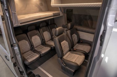 Comfortable interior of a passenger bus with soft seats. The design is made to order. Private covering of cars. Various elements of the bus interior.
