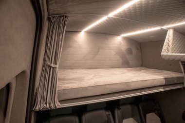 Comfortable interior of a passenger bus with soft seats. The design is made to order. Private covering of cars. Various elements of the bus interior.