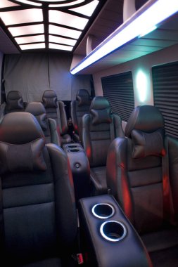 Comfortable interior of a passenger bus with soft seats. The design is made to order. Private covering of cars. Various elements of the bus interior.