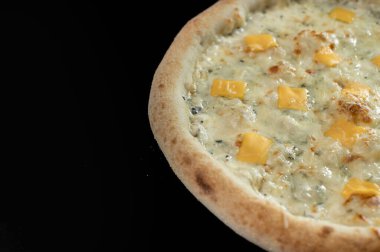 freshly made pizza close-up; details of the pizza application; juicy pizza from the oven with mushrooms, tomatoes and bacon and sprinkled with parmesan cheese