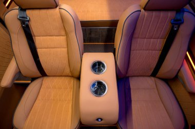 Comfortable interior of a passenger bus with soft seats. The design is made to order. Private covering of cars. Various elements of the bus interior.