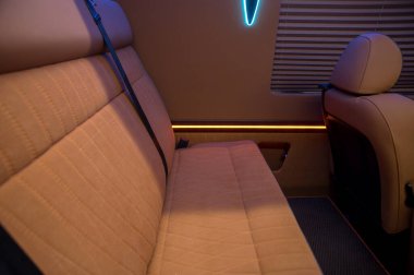 Comfortable interior of a passenger bus with soft seats. The design is made to order. Private covering of cars. Various elements of the bus interior.