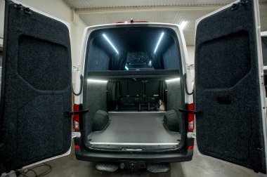 Comfortable interior of a passenger bus with soft seats. The design is made to order. Private covering of cars. Various elements of the bus interior.