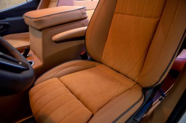 Comfortable interior of a passenger bus with soft seats. The design is made to order. Private covering of cars. Various elements of the bus interior.