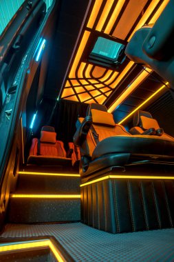 Comfortable interior of a passenger bus with soft seats. The design is made to order. Private covering of cars. Various elements of the bus interior.