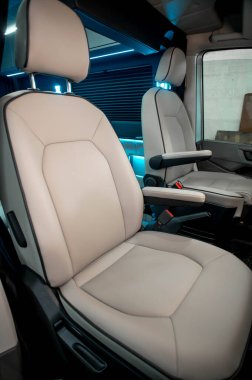Comfortable interior of a passenger bus with soft seats. The design is made to order. Private covering of cars. Various elements of the bus interior.