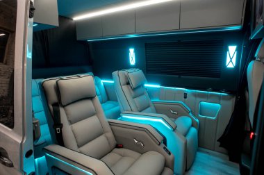 Comfortable interior of a passenger bus with soft seats. The design is made to order. Private covering of cars. Various elements of the bus interior.