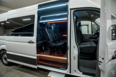 Comfortable interior of a passenger bus with soft seats. The design is made to order. Private covering of cars. Various elements of the bus interior.