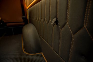 Comfortable interior of a passenger bus with soft seats. The design is made to order. Private covering of cars. Various elements of the bus interior.