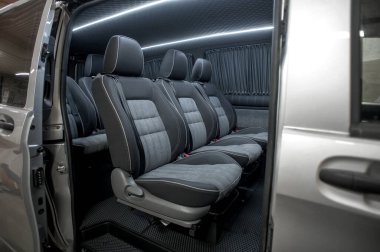 Comfortable interior of a passenger bus with soft seats. The design is made to order. Private covering of cars. Various elements of the bus interior.
