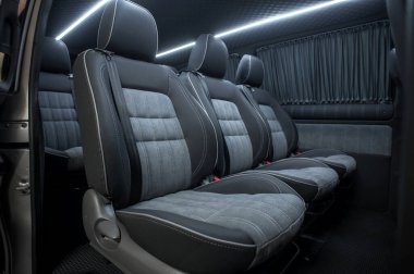 Comfortable interior of a passenger bus with soft seats. The design is made to order. Private covering of cars. Various elements of the bus interior.