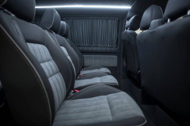 Comfortable interior of a passenger bus with soft seats. The design is made to order. Private covering of cars. Various elements of the bus interior.