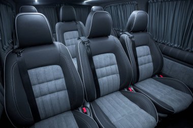 Comfortable interior of a passenger bus with soft seats. The design is made to order. Private covering of cars. Various elements of the bus interior.