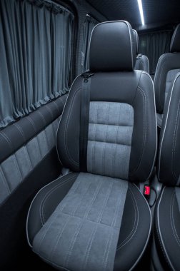 Comfortable interior of a passenger bus with soft seats. The design is made to order. Private covering of cars. Various elements of the bus interior.