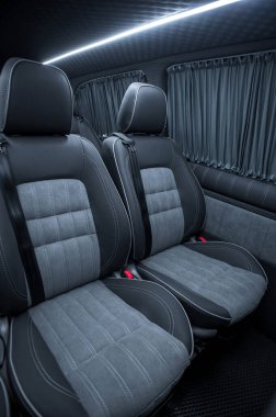 Comfortable interior of a passenger bus with soft seats. The design is made to order. Private covering of cars. Various elements of the bus interior.