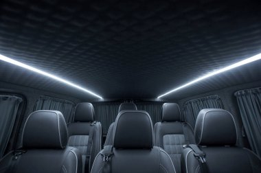 Comfortable interior of a passenger bus with soft seats. The design is made to order. Private covering of cars. Various elements of the bus interior.