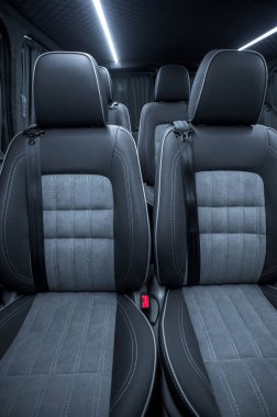Comfortable interior of a passenger bus with soft seats. The design is made to order. Private covering of cars. Various elements of the bus interior.