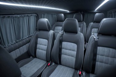 Comfortable interior of a passenger bus with soft seats. The design is made to order. Private covering of cars. Various elements of the bus interior.