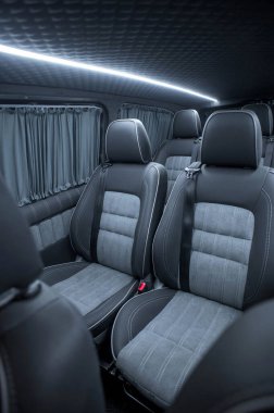 Comfortable interior of a passenger bus with soft seats. The design is made to order. Private covering of cars. Various elements of the bus interior.