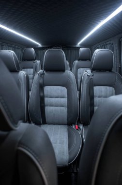 Comfortable interior of a passenger bus with soft seats. The design is made to order. Private covering of cars. Various elements of the bus interior.
