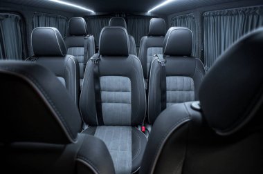 Comfortable interior of a passenger bus with soft seats. The design is made to order. Private covering of cars. Various elements of the bus interior.