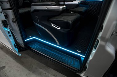 Comfortable interior of a passenger bus with soft seats. The design is made to order. Private covering of cars. Various elements of the bus interior.