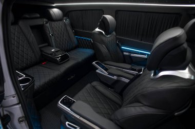 Comfortable interior of a passenger bus with soft seats. The design is made to order. Private covering of cars. Various elements of the bus interior.
