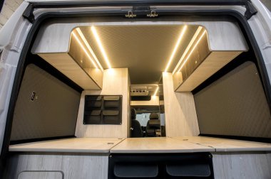 Comfortable interior of a passenger bus with soft seats. The design is made to order. Private covering of cars. Various elements of the bus interior.