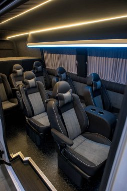 Comfortable interior of a passenger bus with soft seats. The design is made to order. Private covering of cars. Various elements of the bus interior.