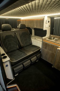 Comfortable interior of a passenger bus with soft seats. The design is made to order. Private covering of cars. Various elements of the bus interior.