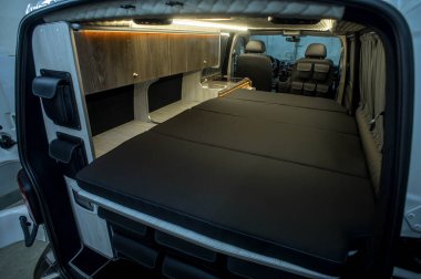 Comfortable interior of a passenger bus with soft seats. The design is made to order. Private covering of cars. Various elements of the bus interior.