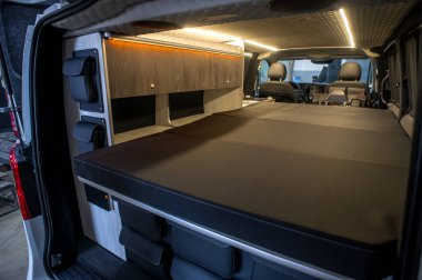 Comfortable interior of a passenger bus with soft seats. The design is made to order. Private covering of cars. Various elements of the bus interior.