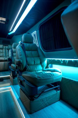 Comfortable interior of a passenger bus with soft seats. The design is made to order. Private covering of cars. Various elements of the bus interior.