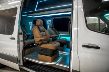 Comfortable interior of a passenger bus with soft seats. The design is made to order. Private covering of cars. Various elements of the bus interior.