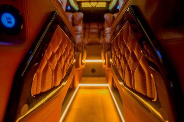 Comfortable interior of a passenger bus with soft seats. The design is made to order. Private covering of cars. Various elements of the bus interior.