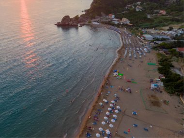 Aerial drone view over Pelekas Kontogialos beach at sunset. Corfu, Greece. clipart