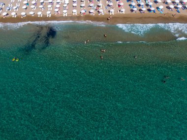 Yunanistan 'ın Korfu adasındaki Agios Gordios egzotik plajı. Agios Gordios plajı, Korfu adası, Yunanistan. Agios Gordios plajının panoramik manzarası, kumlu deniz kıyıları, plaj şemsiyeleri ve şezlonglar..