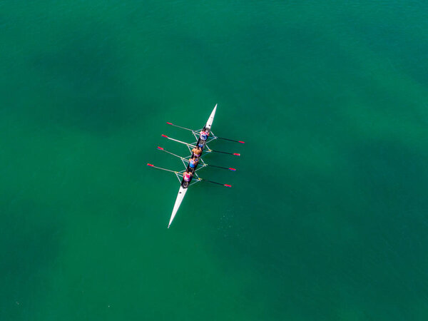 corfu, corfu, Greece. September 14, 2021: Rowing team glides across emerald water.