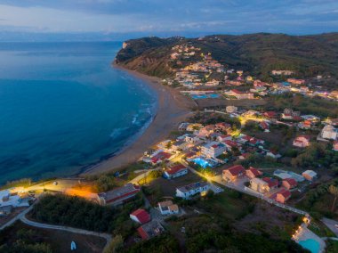 Alacakaranlıktaki sahil kasabası, hava manzaralı. Sakin sahil ve okyanus.