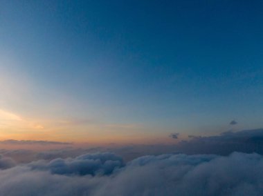 Sunset above a sea of clouds.  A breathtaking view from above. clipart