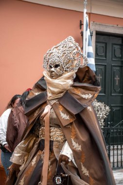 Gösterişli maske ve barok elbiseler içinde, festivalin ruhunu somutlaştıran abartılı bir karnaval eğlencesi..
