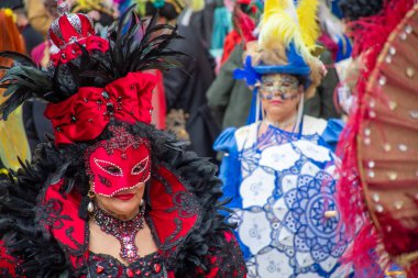 İnsanlar süslü kostümleri ve süslü maskeleriyle Venedik karnavalında kutlama yapıyorlar..