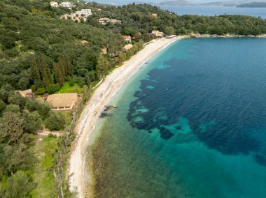 Turkuaz suları ve yemyeşil suları olan tenha bir sahil manzarası..