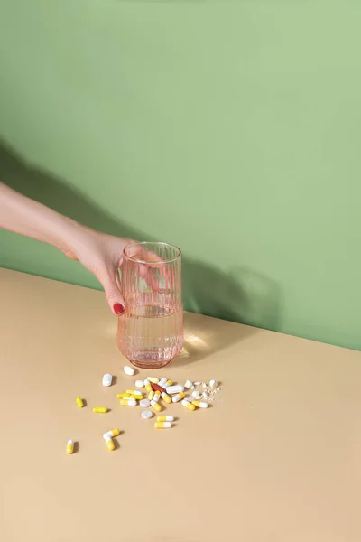 Female Hand Putting Glass Water Handful Pills Table Well Being Royalty Free Stock Images