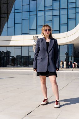 Şehrin önünde poz veren genç bir kadın..