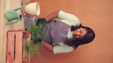 Attractive woman Blogger Tells Subscribers About Caring for House Plants