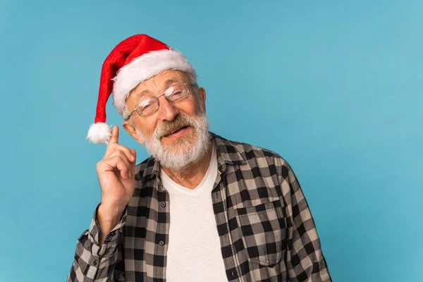 Portrait of happy Santa Claus excited looking at camera and holds small christmas tree