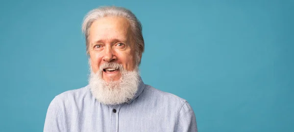 stock image Banner portrait of surprised grey hair beard grandfather old man over blue colour background with copy space