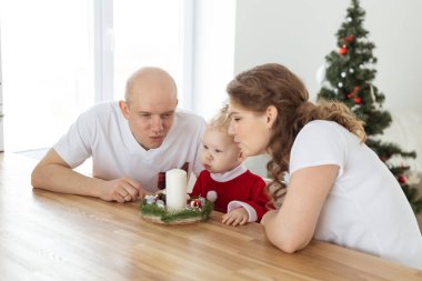 Child girl dressed in christmas dress with cochlear implants having fun at home - hearing aid and innovating technologies for treatment deafness