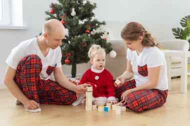 Toddler child with cochlear implant decorating christmas tree deafness and innovating medical technologies for hearing aid